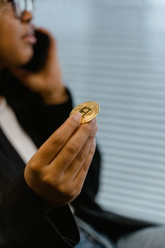 Terra Station and DeFi: Exploring Decentralized Finance on Terra Portrait of a woman holding a Bitcoin, symbolizing digital finance and cryptocurrency trends.